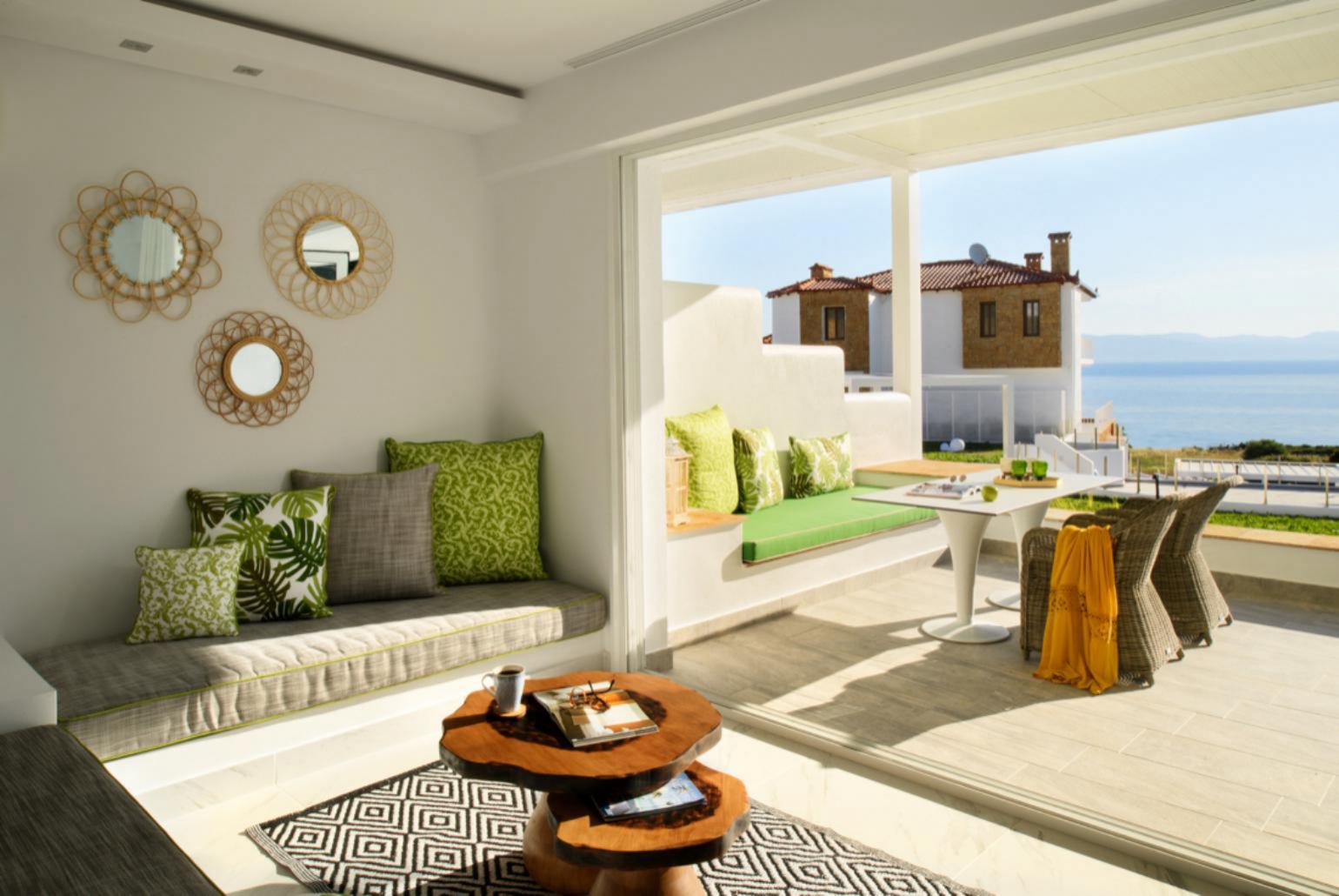 Living room with sofas, dining area, A/C, WiFi internet, satellite TV, and terrace access with sea views