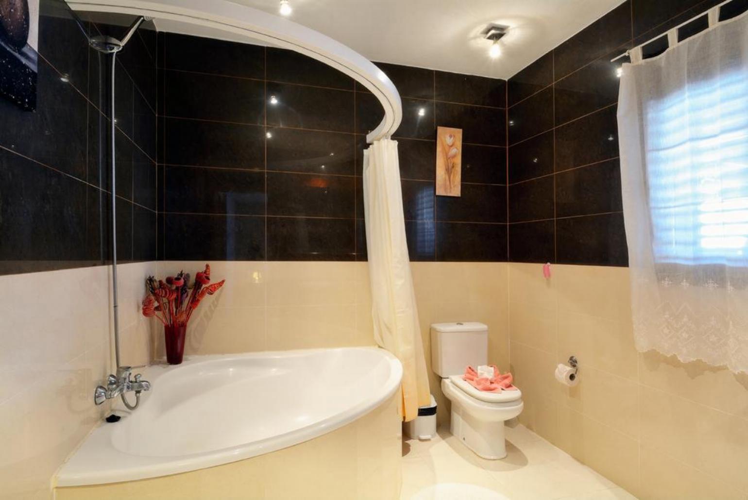 Bathroom with bath and shower