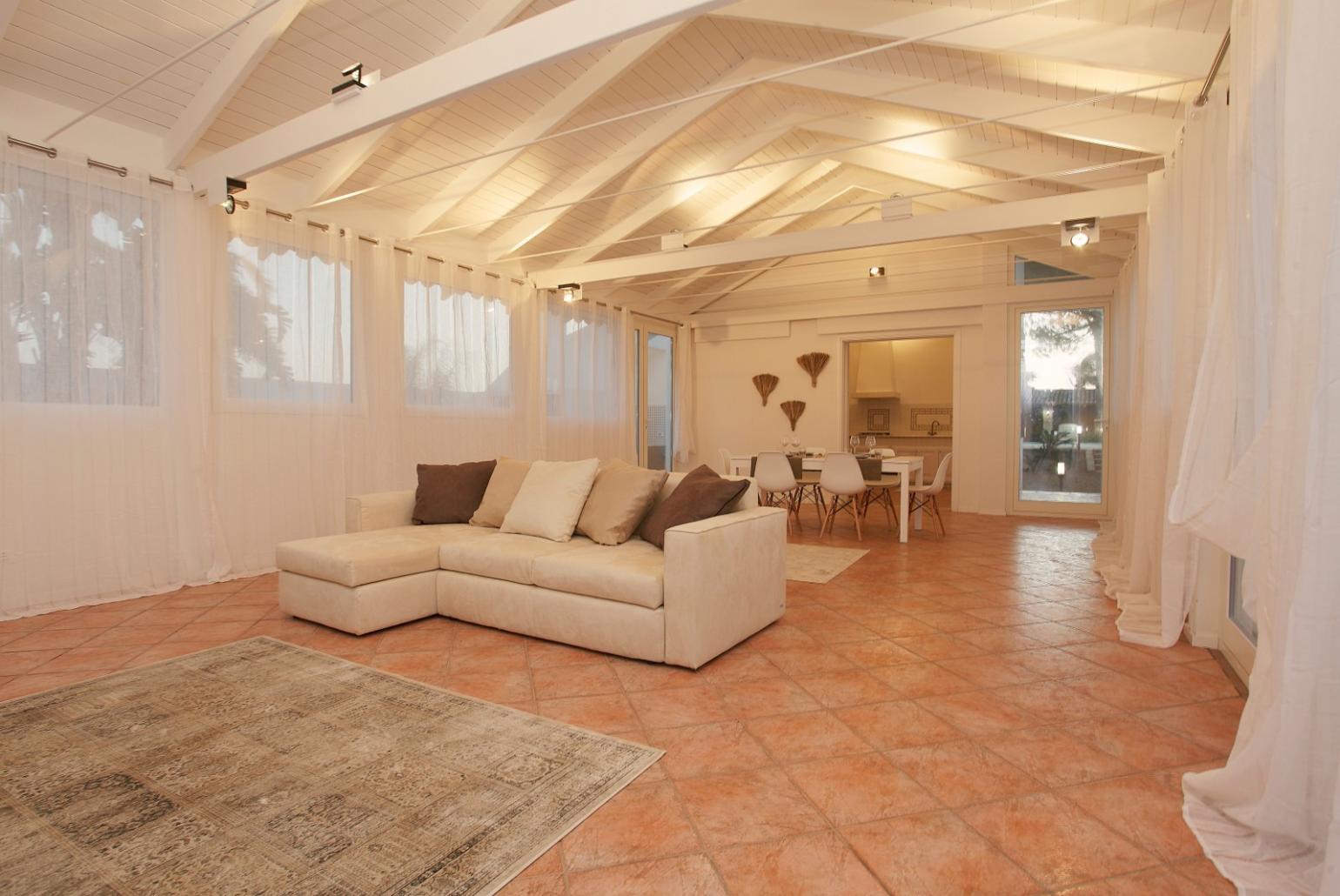 Living room with sofa, dining area, A/C, WiFi internet, and satellite TV