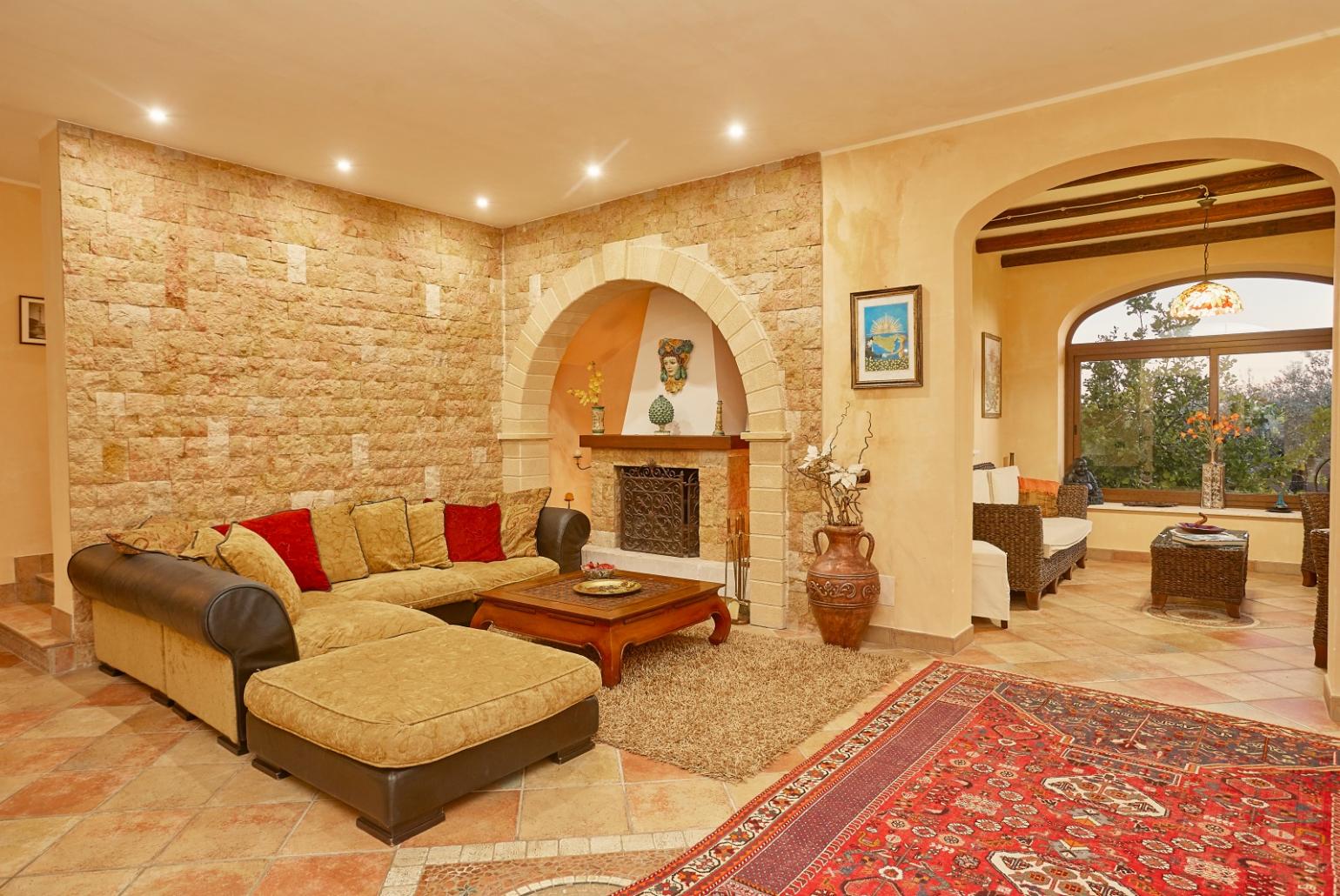 Living room with sofas, ornamental fireplace, A/C, WiFi internet, and satellite TV