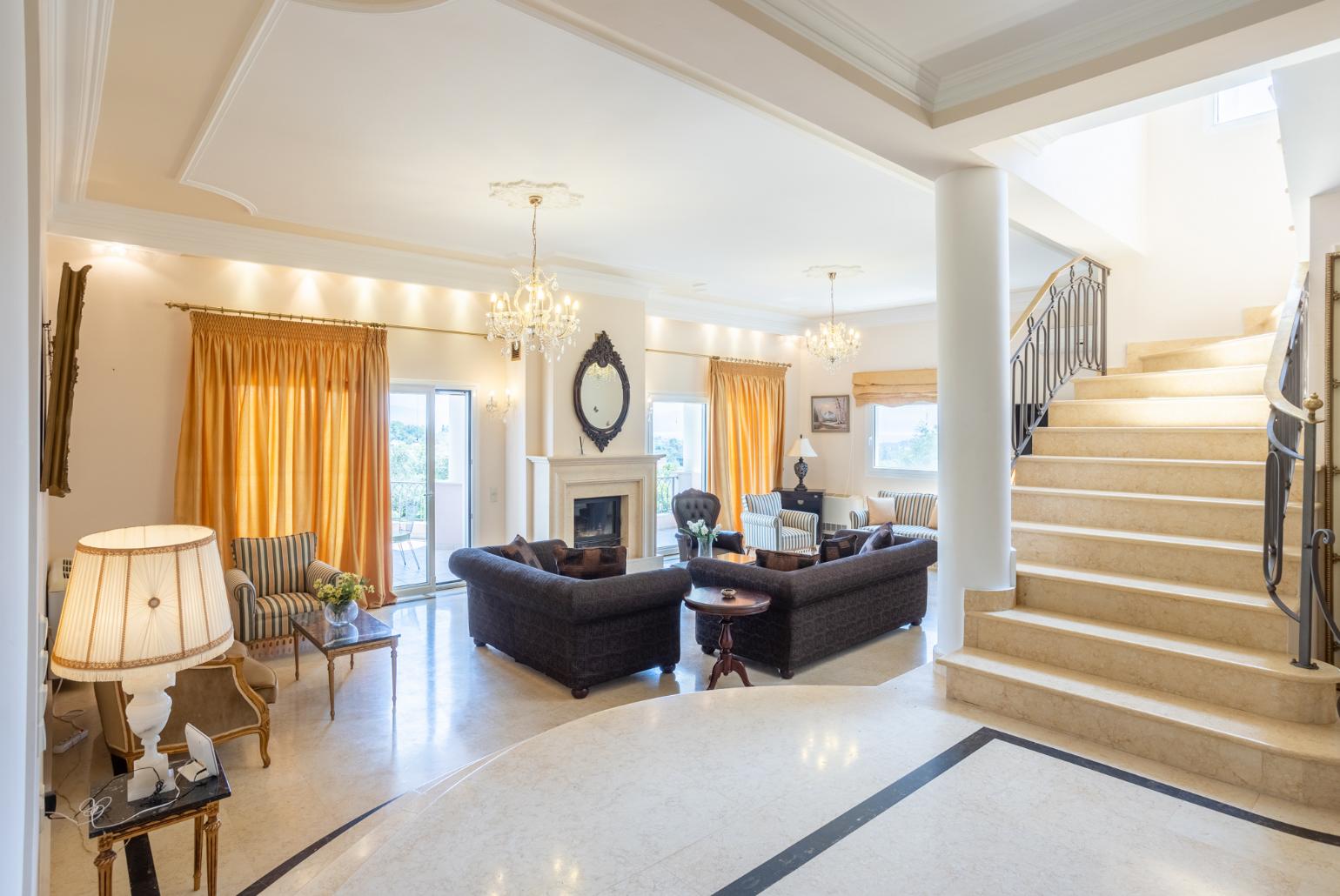 Living room with sofas, dining area, ornamental fireplace, A/C, WiFi internet, and satellite TV, and terrace access
