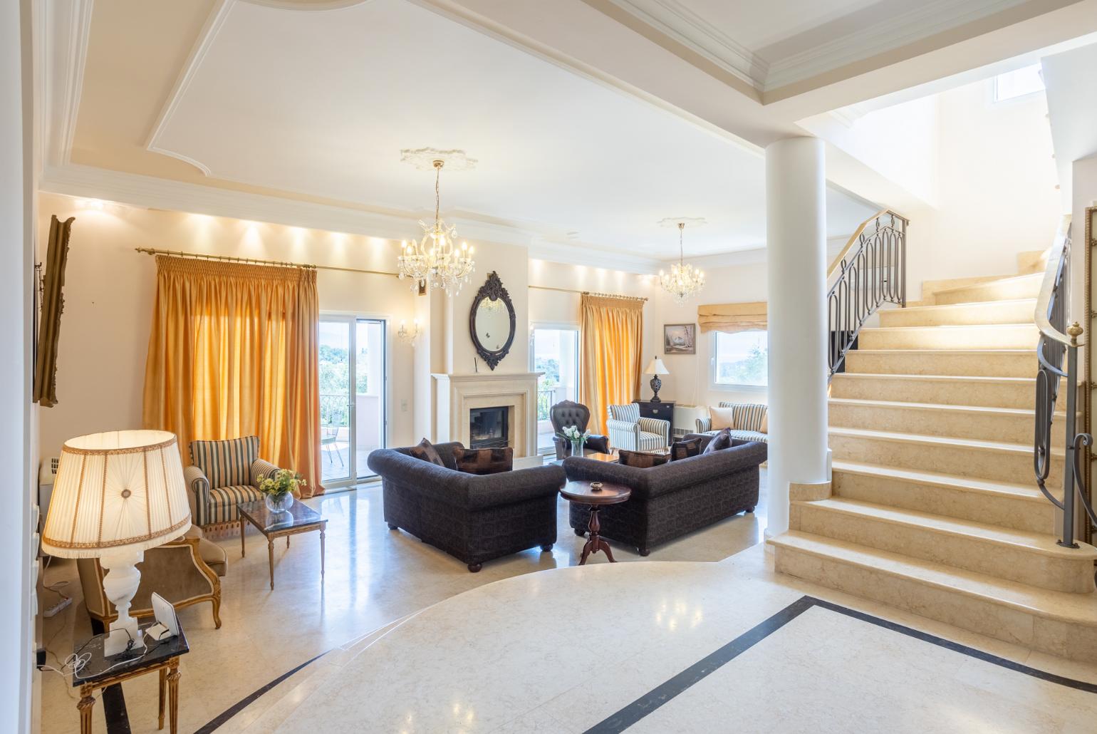 Living room with sofas, dining area, ornamental fireplace, A/C, WiFi internet, and satellite TV, and terrace access