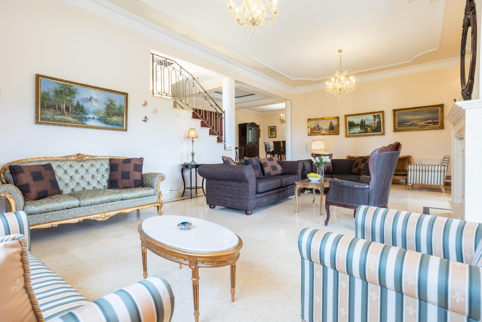 Living room with sofas, dining area, ornamental fireplace, A/C, WiFi internet, and satellite TV, and terrace access