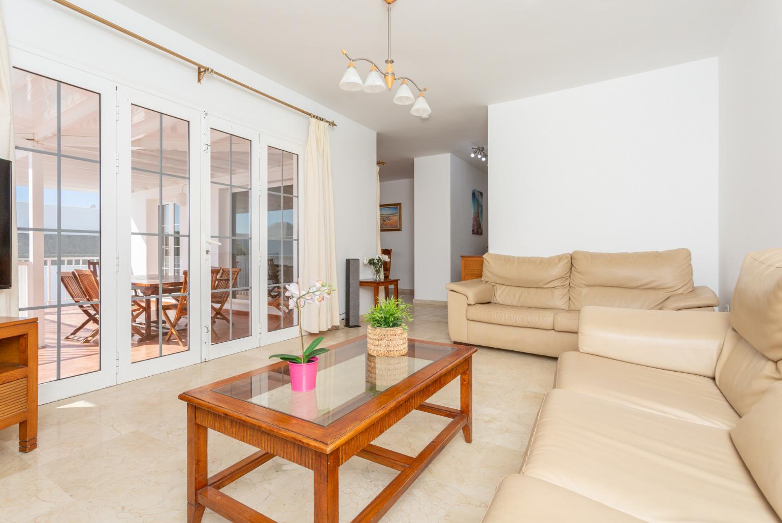 Living room with sofas, A/C, WiFi internet, satellite TV, and terrace access