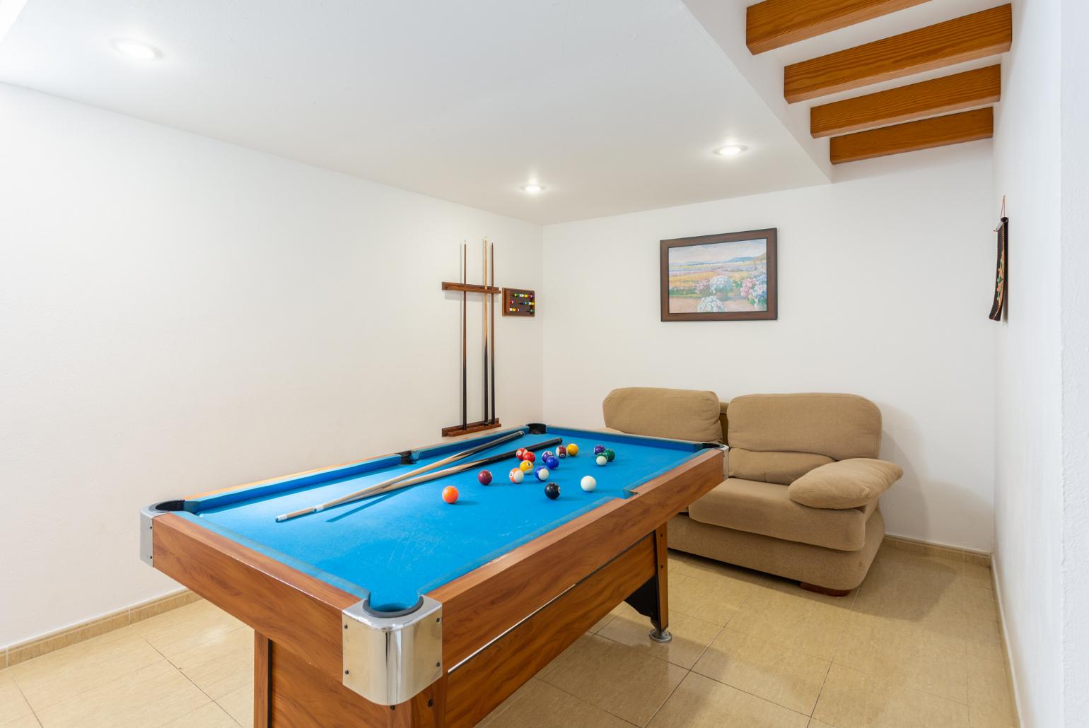 Game room with pool table and sofa