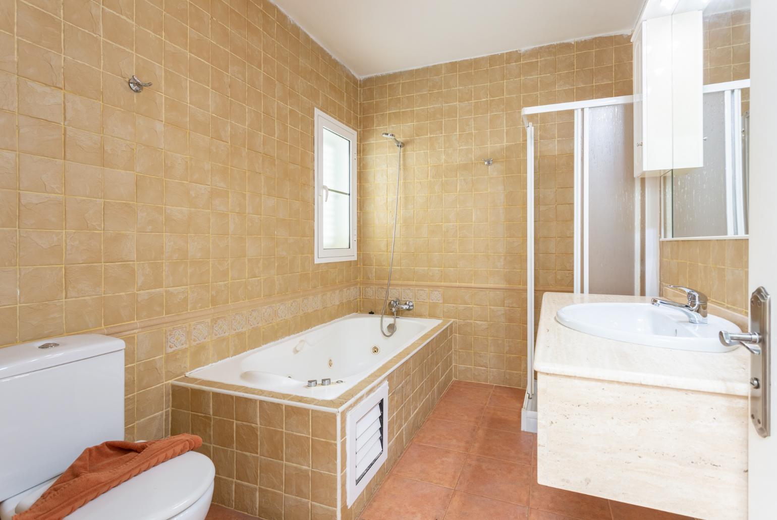 En suite bathroom with bath and shower