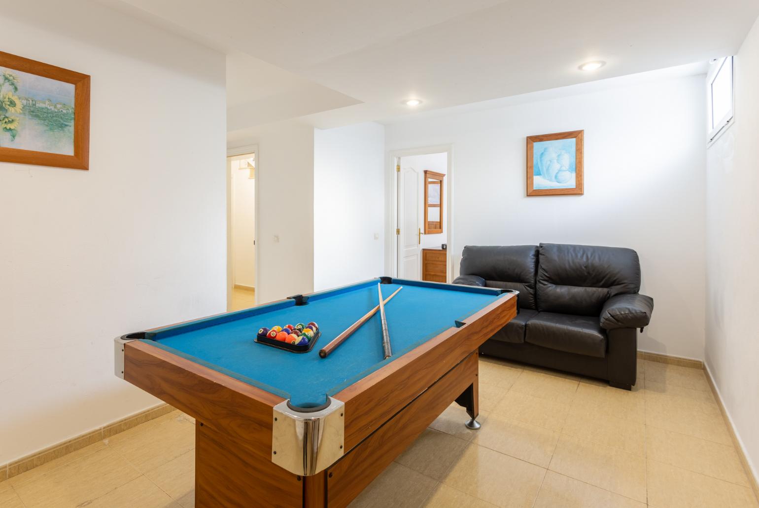 Game room with pool table and sofa