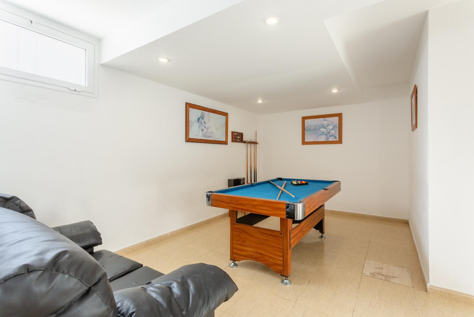 Game room with pool table and sofa