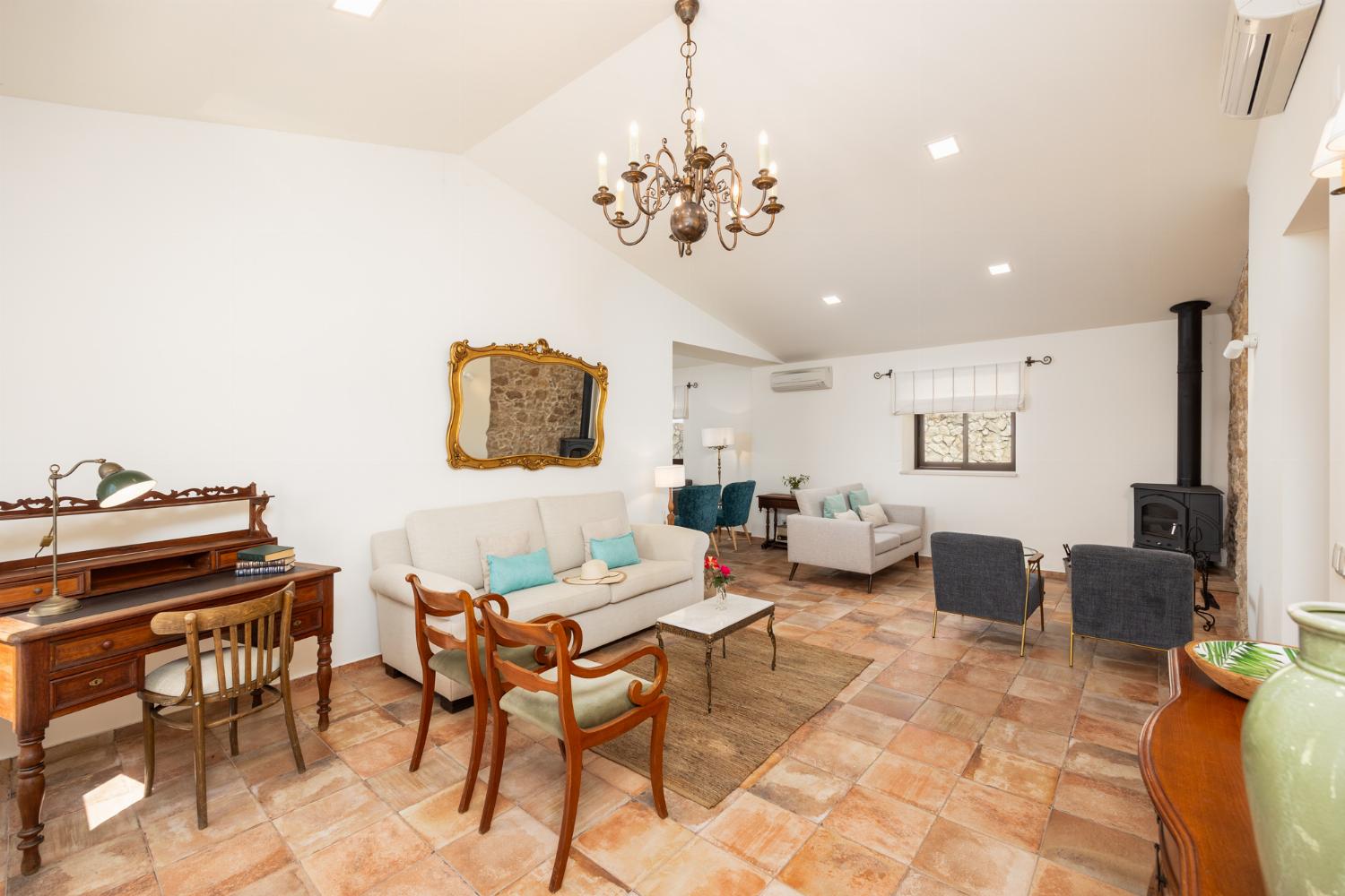 Living room with sofas, ornamental fireplace, A/C, WiFi internet, and satellite TV