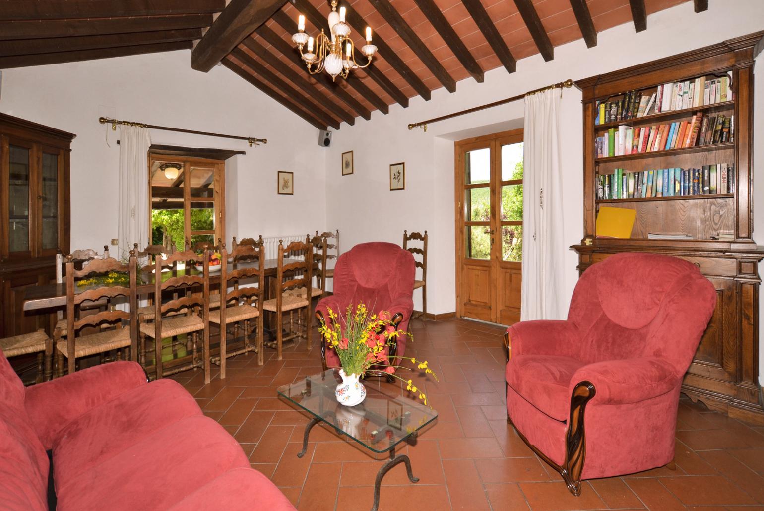 Living room with sofas, dining area, ornamental fireplace, and satellite TV