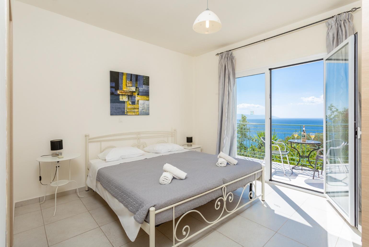 Double bedroom with en suite bathroom, A/C, and upper terrace access with panoramic sea views