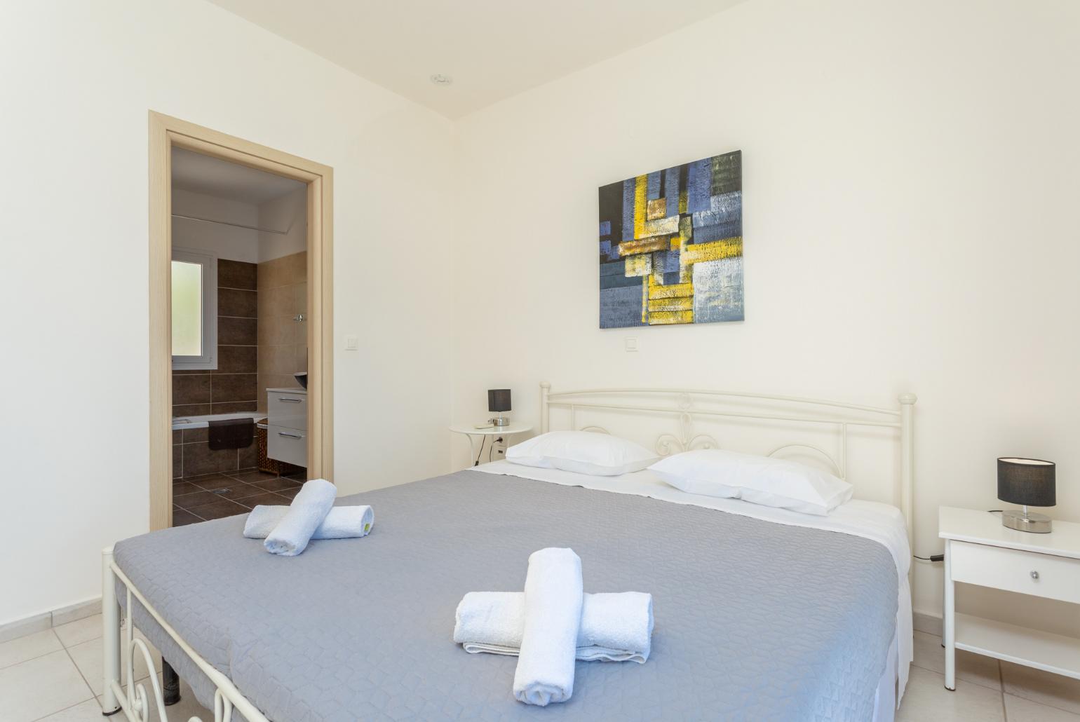 Double bedroom with en suite bathroom, A/C, and upper terrace access with panoramic sea views