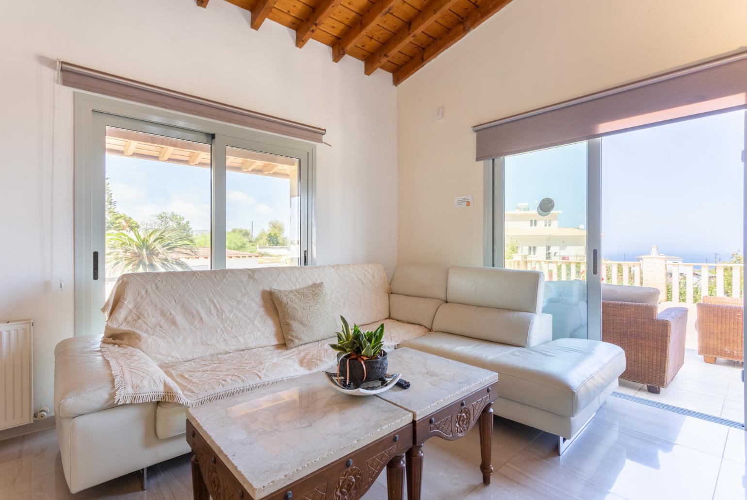 Open-plan living room with sofas, dining area, kitchen, ornamental fireplace, mezzanine, WiFi internet, and TV