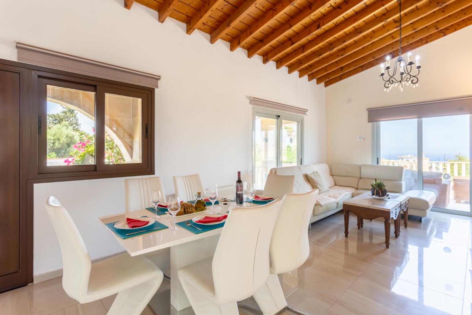 Open-plan living room with sofas, dining area, kitchen, ornamental fireplace, mezzanine, WiFi internet, and TV