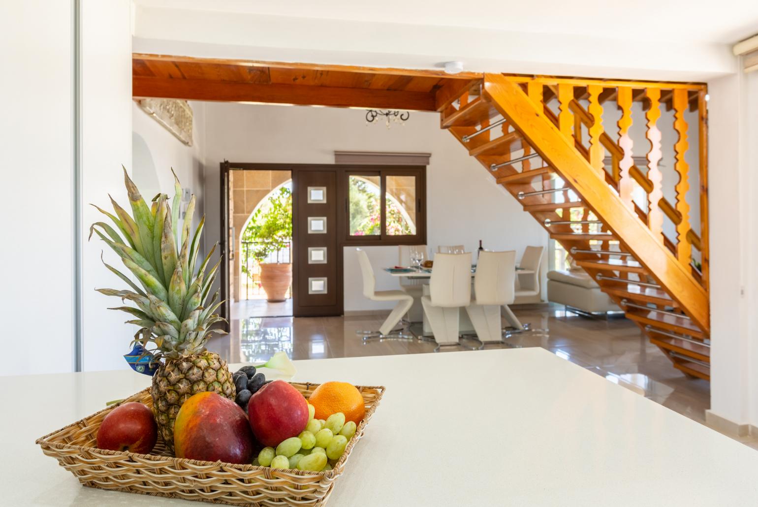 Open-plan living room with sofas, dining area, kitchen, ornamental fireplace, mezzanine, WiFi internet, and TV