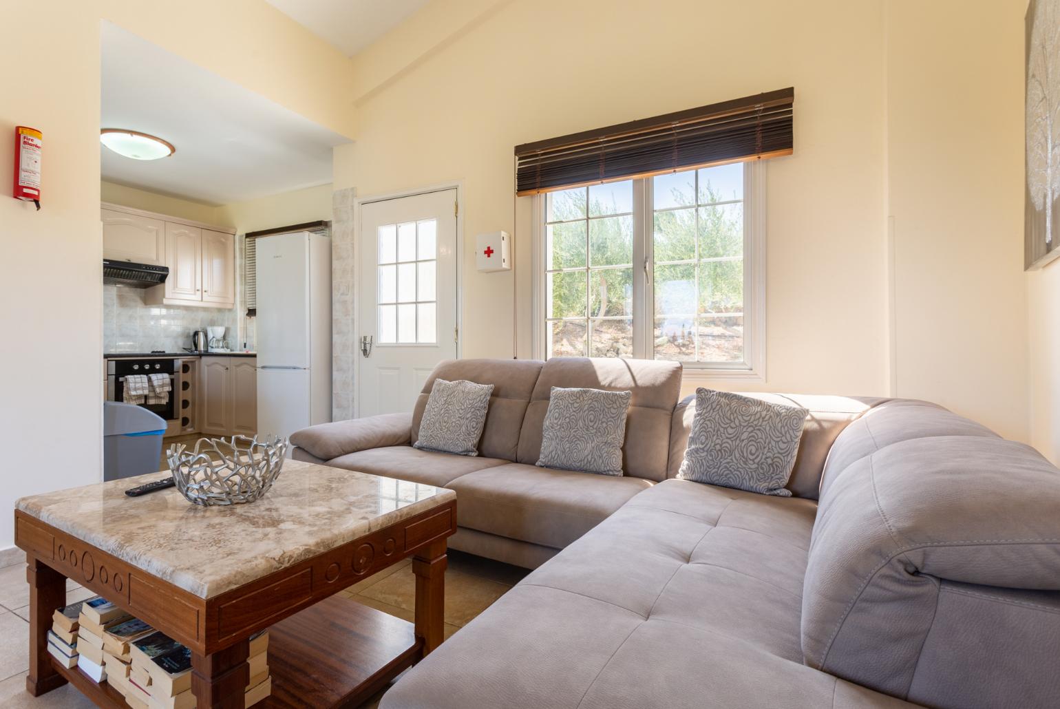 Open-plan living room with sofas, kitchen, WiFi internet, and TV