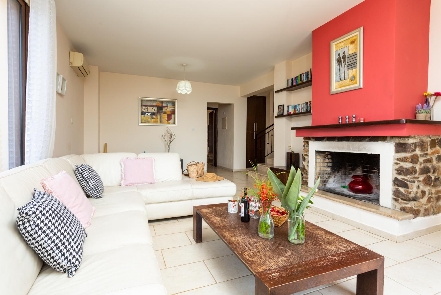 Living room with sofa, ornamental fireplace, A/C, WiFi internet, satellite TV, and sea views