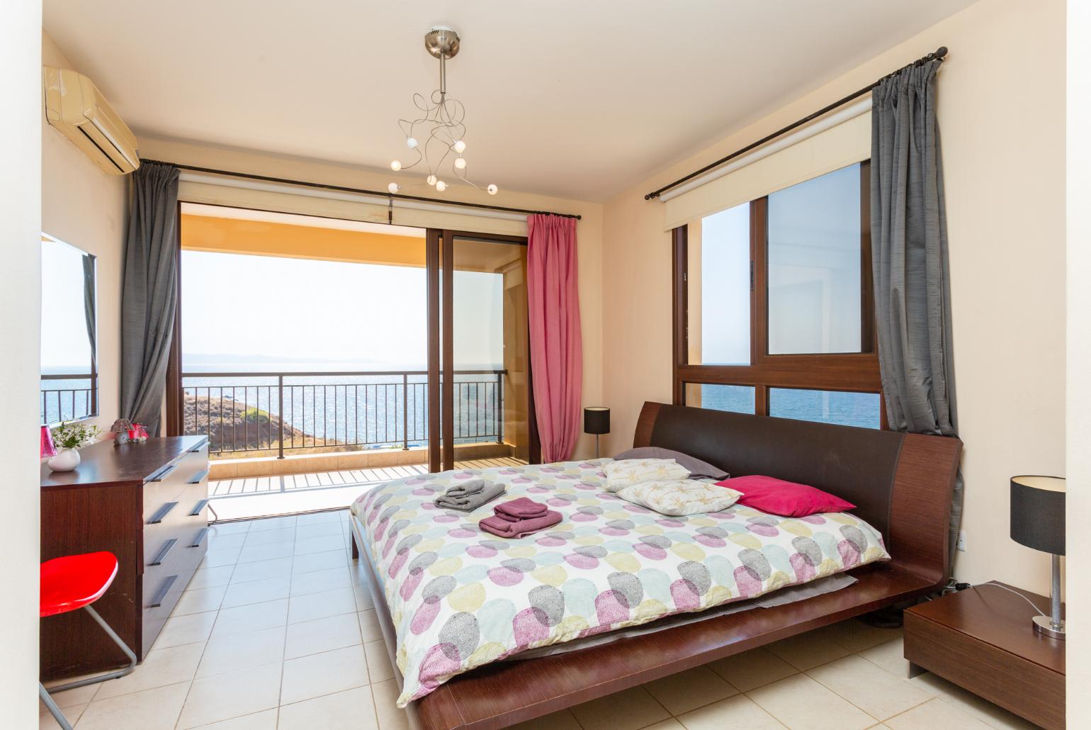 Double bedroom with en suite bathroom, A/C, and terrace access with sea views