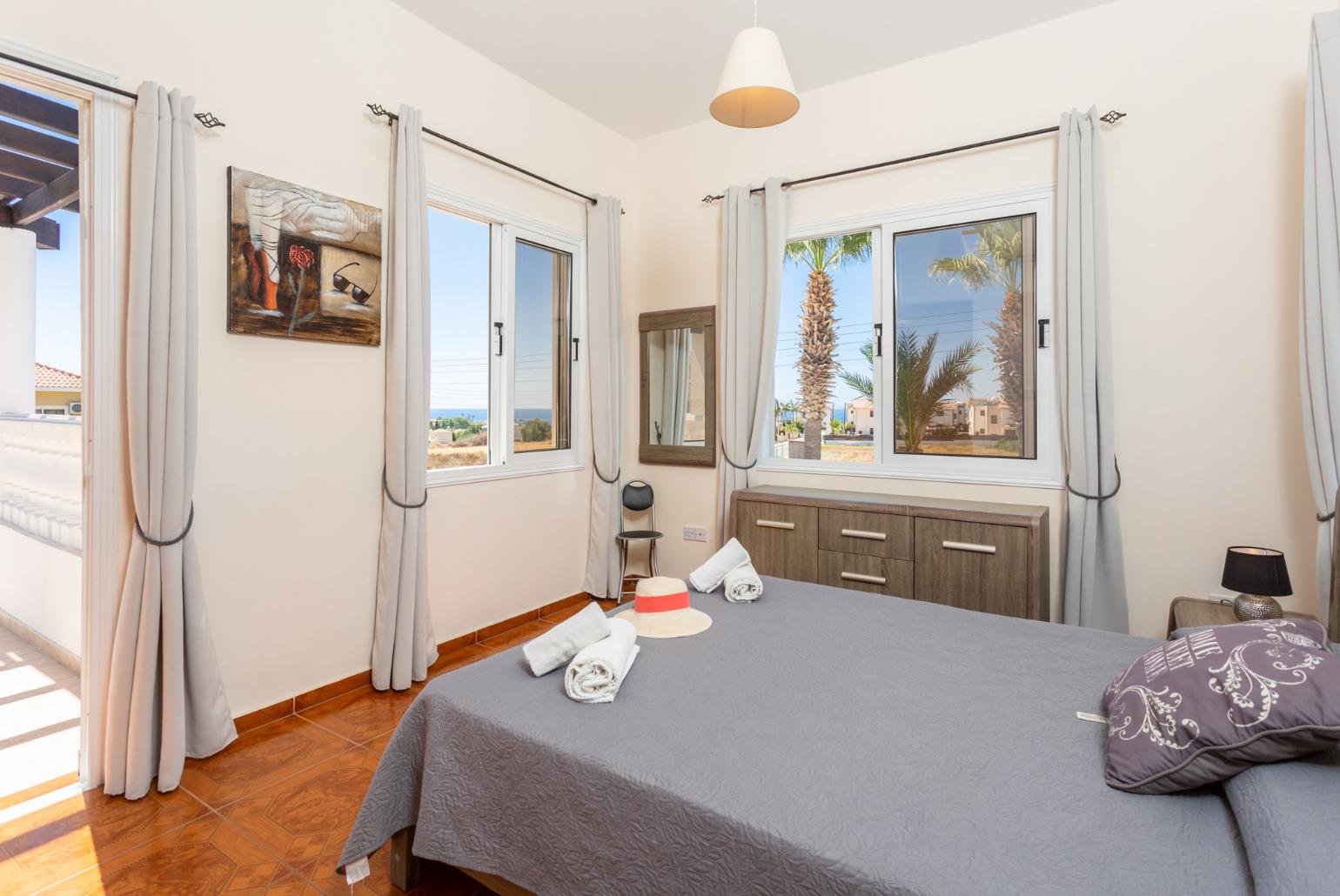 Double bedroom with en suite bathroom, A/C, and upper terrace access with sea views