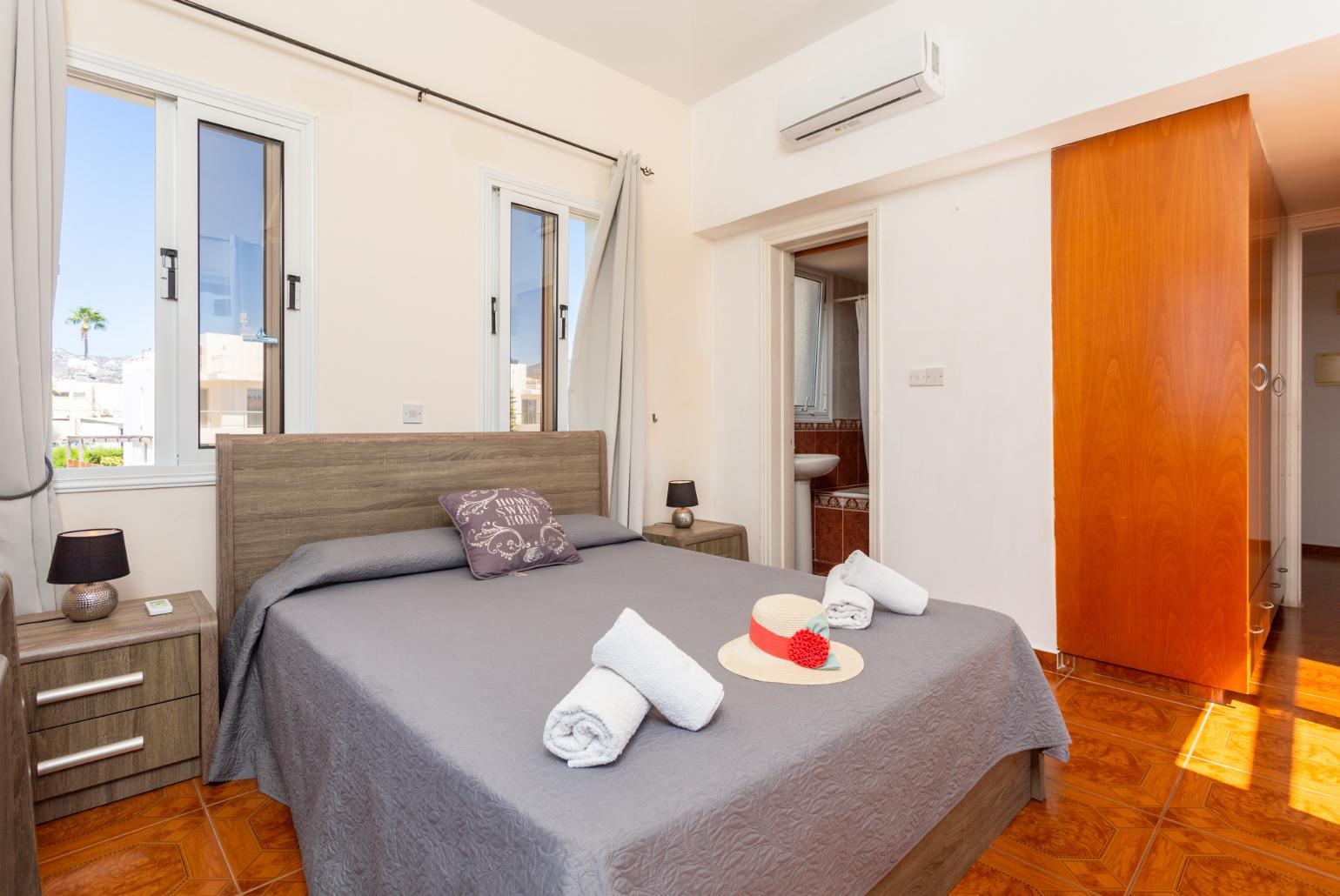 Double bedroom with en suite bathroom, A/C, and upper terrace access with sea views