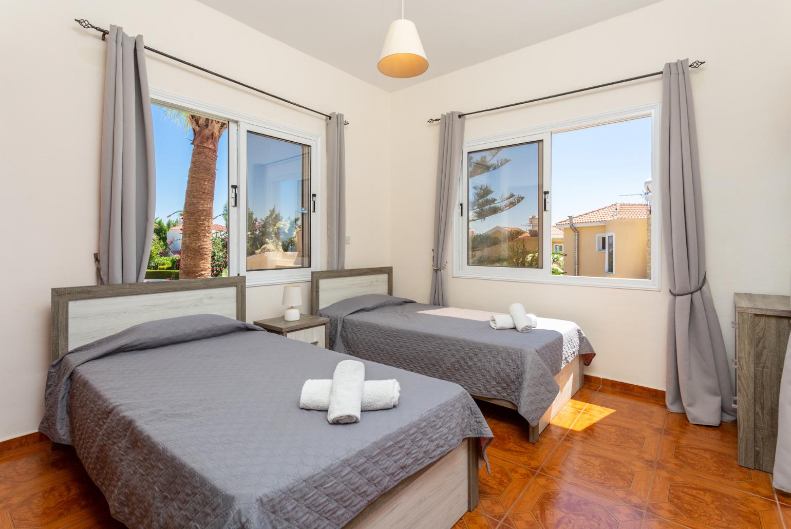 Twin bedroom with en suite bathroom, A/C, and upper terrace access with sea views