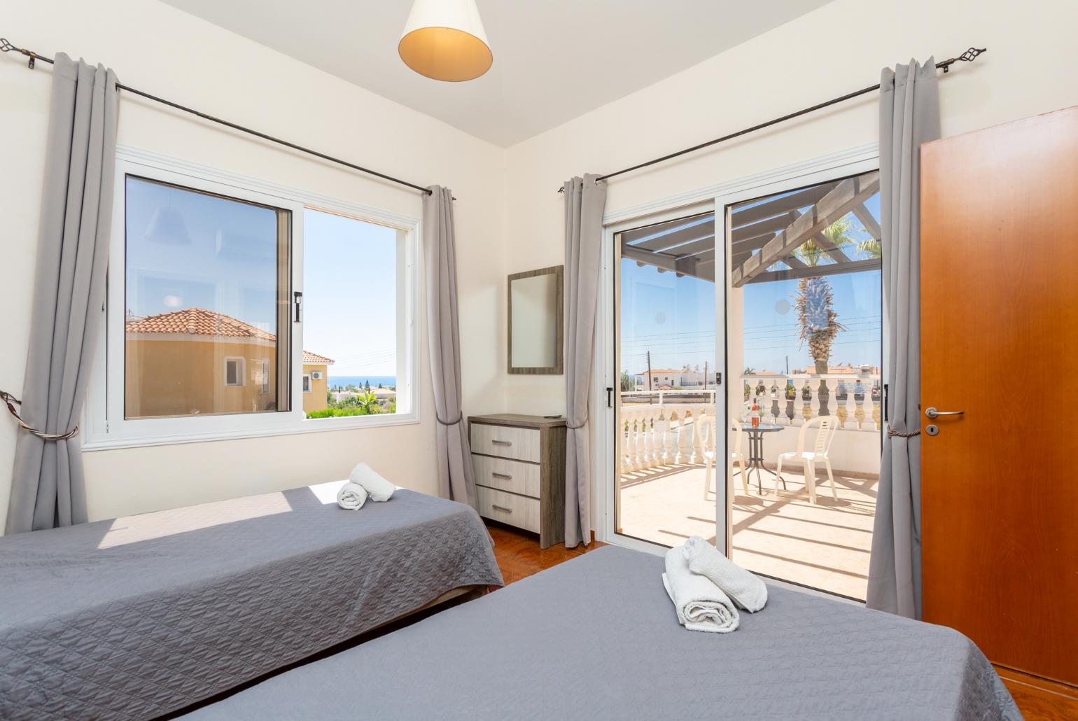 Twin bedroom with en suite bathroom, A/C, and upper terrace access with sea views