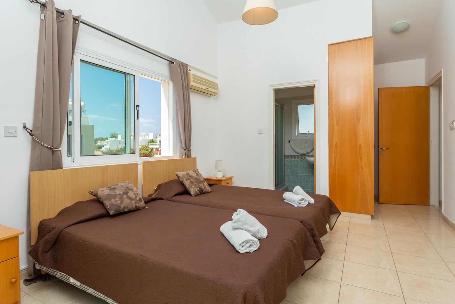 Twin bedroom with en suite bathroom, A/C, and upper terrace access