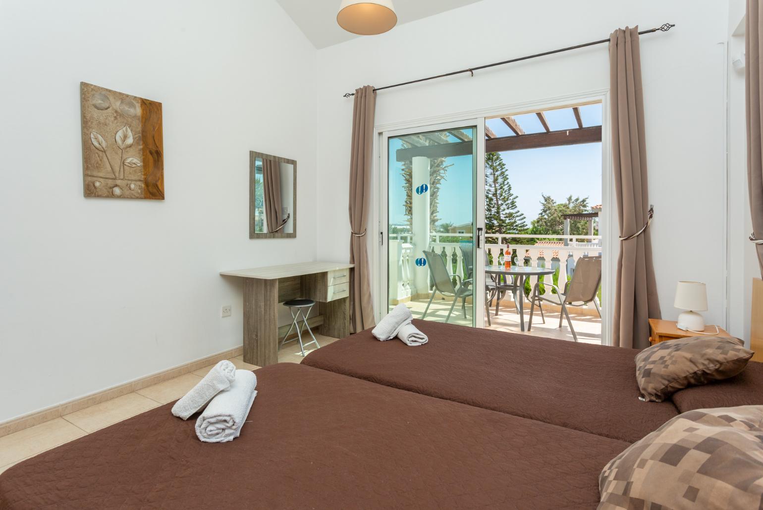 Twin bedroom with en suite bathroom, A/C, and upper terrace access