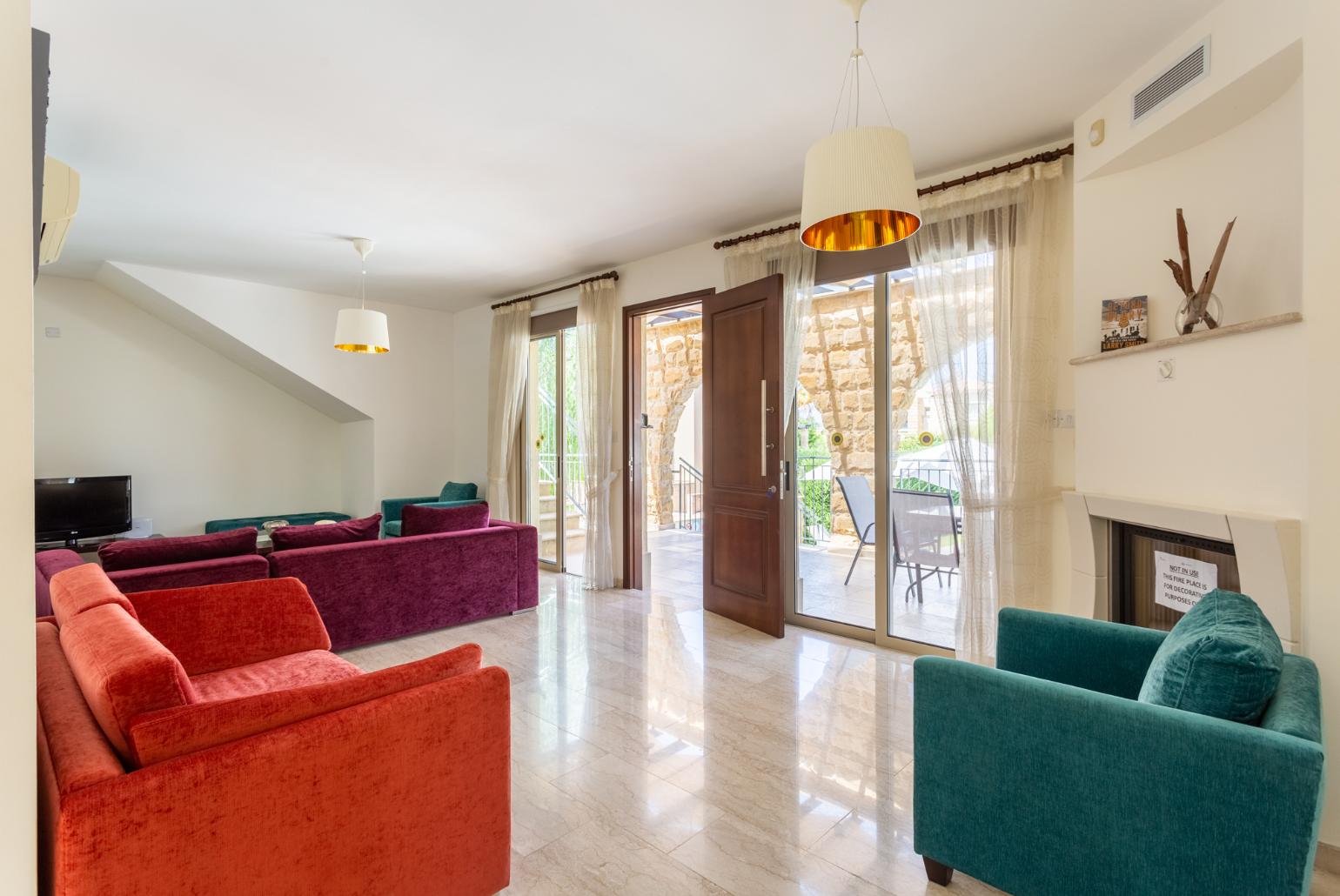 Living room with sofas, ornamental fireplace, A/C, WiFi internet, and TV