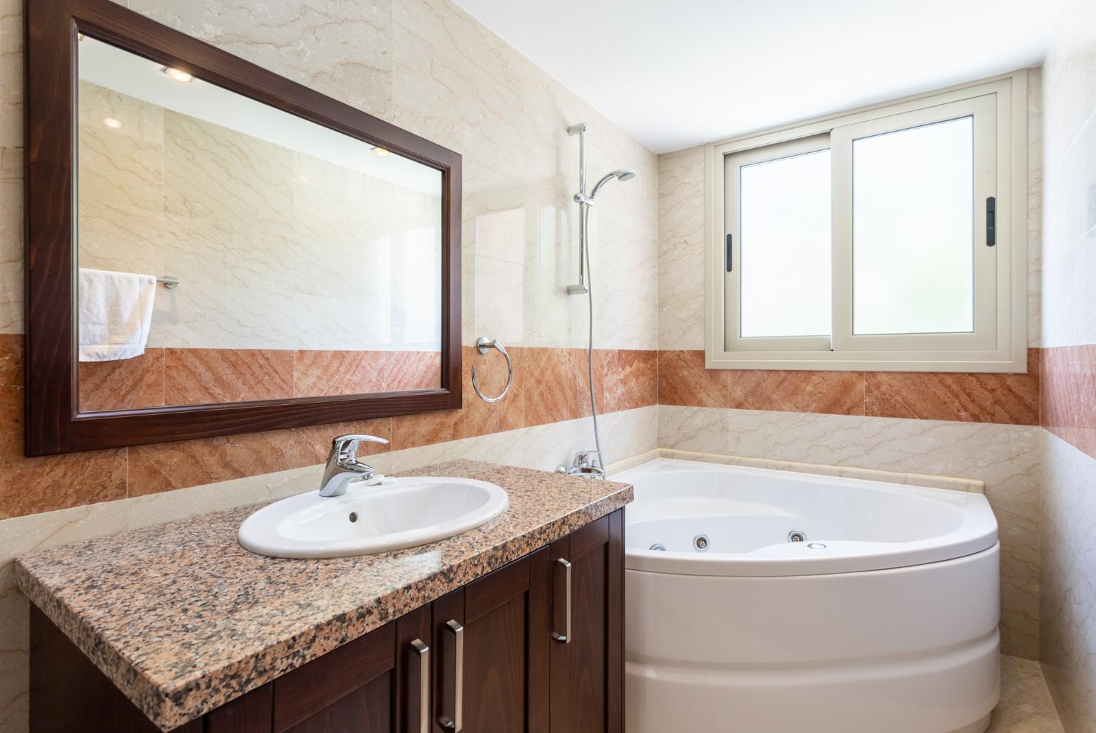 En suite bathroom with shower and spa bath