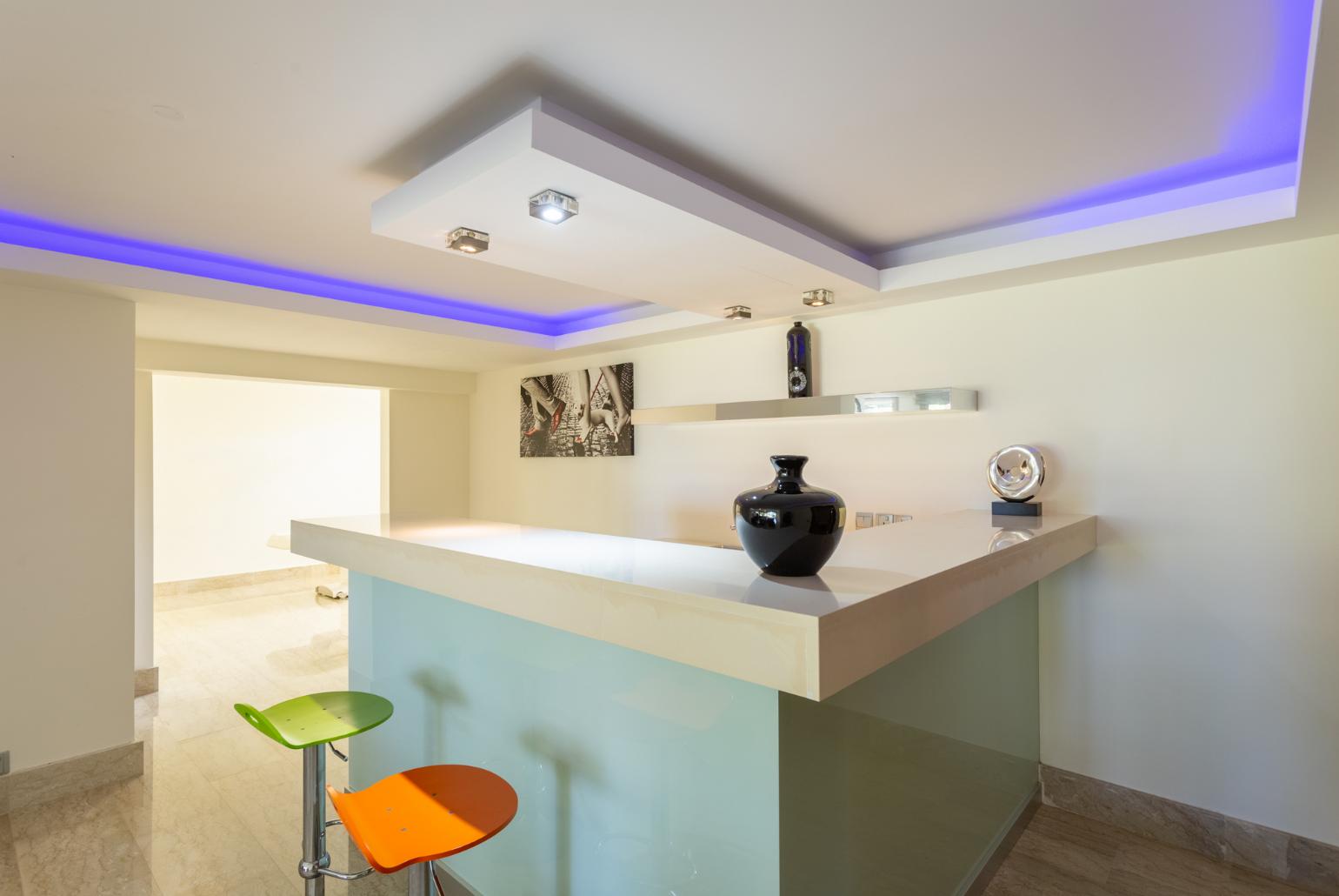 Living room on lower level with sofas, bar, jacuzzi, gym, and A/C