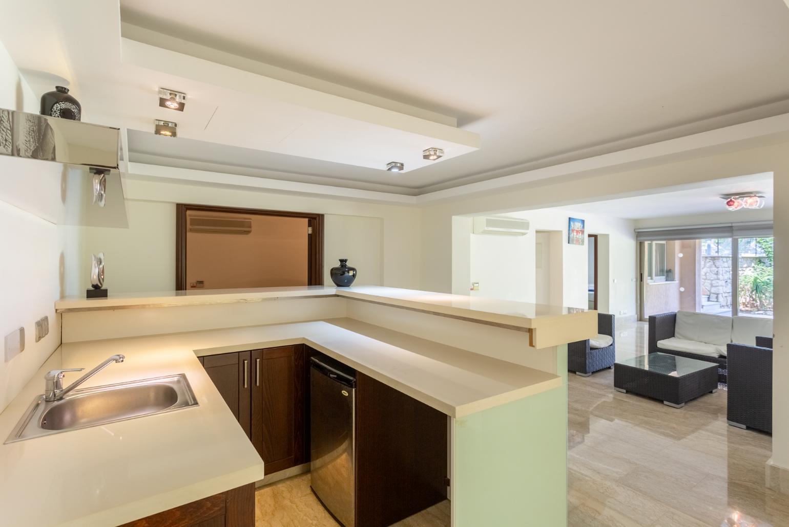 Living room on lower level with sofas, bar, jacuzzi, gym, and A/C