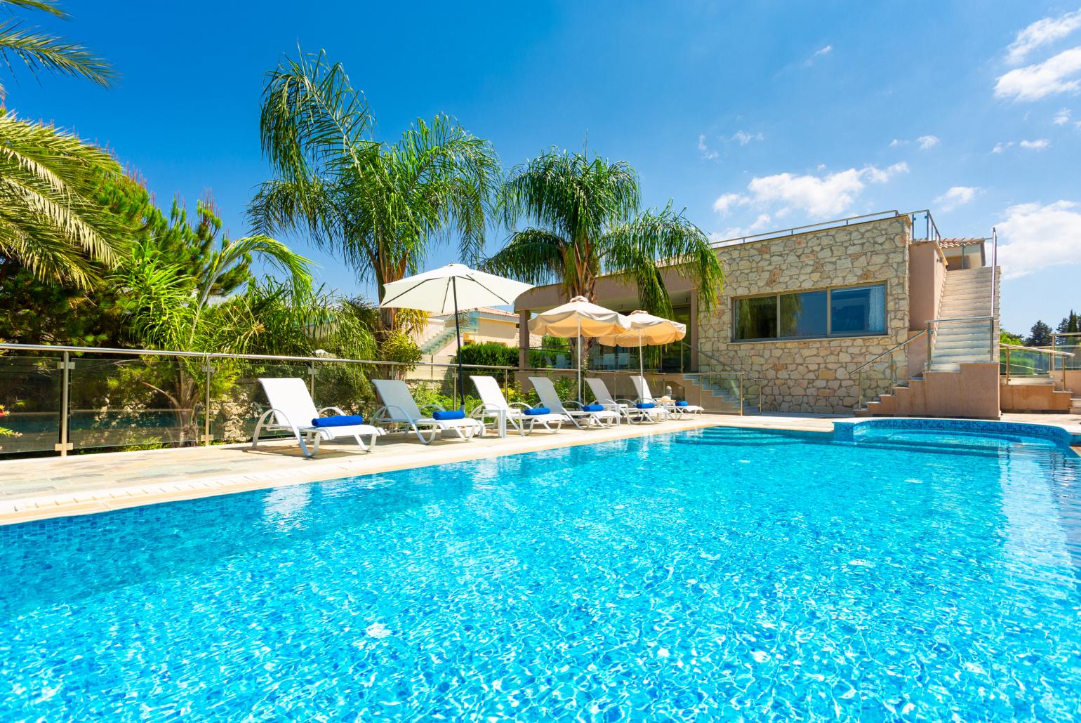 Private infinity pool, terrace, and garden with sea views