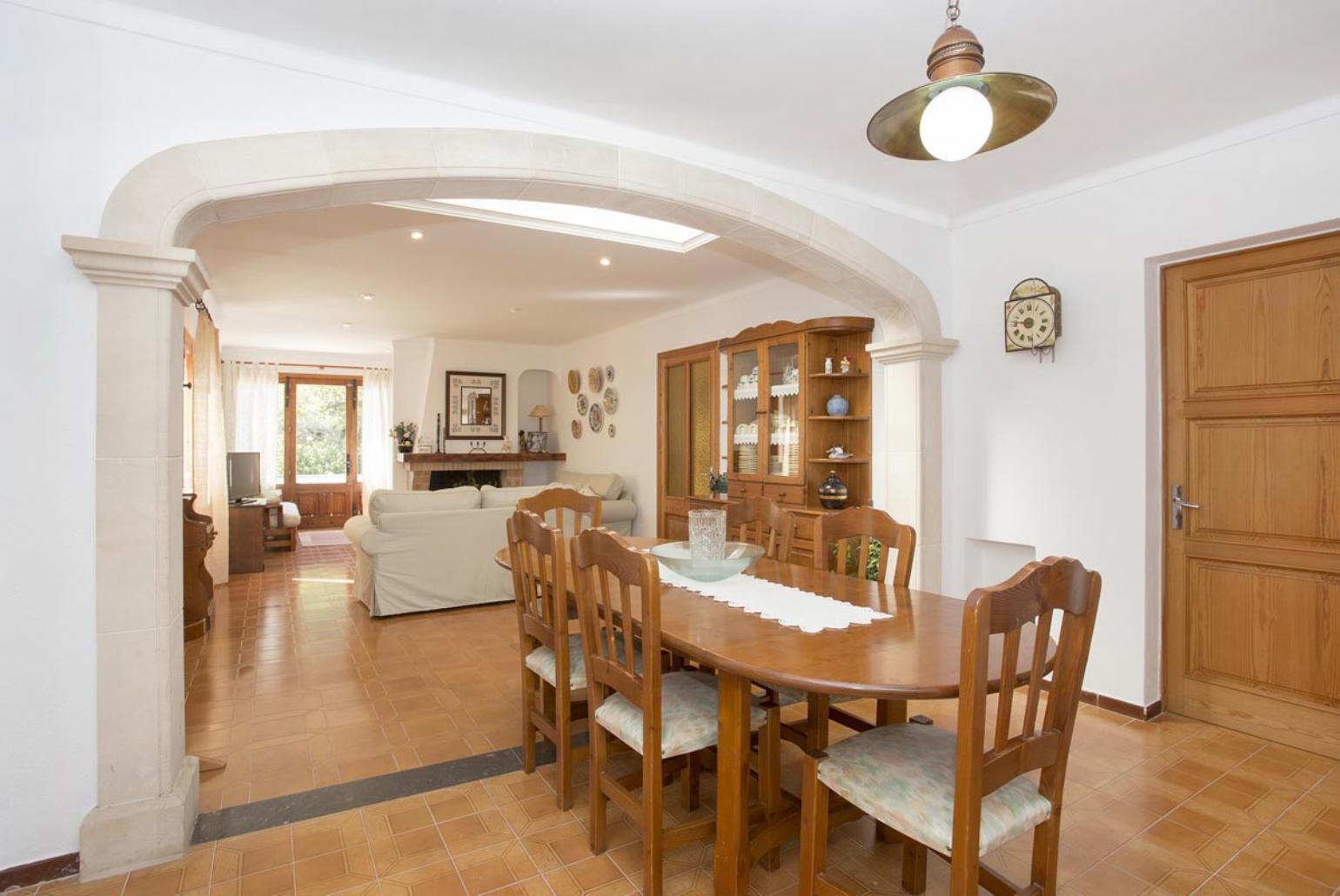 Living room with sofas, dining area, ornamental fireplace, A/C, WiFi internet, and satellite TV