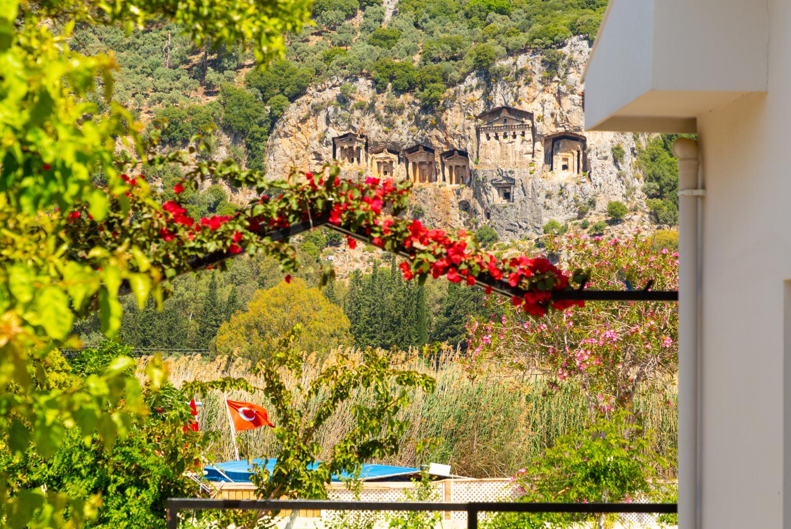 View of ancient Lycian rock tombs as seen from villa