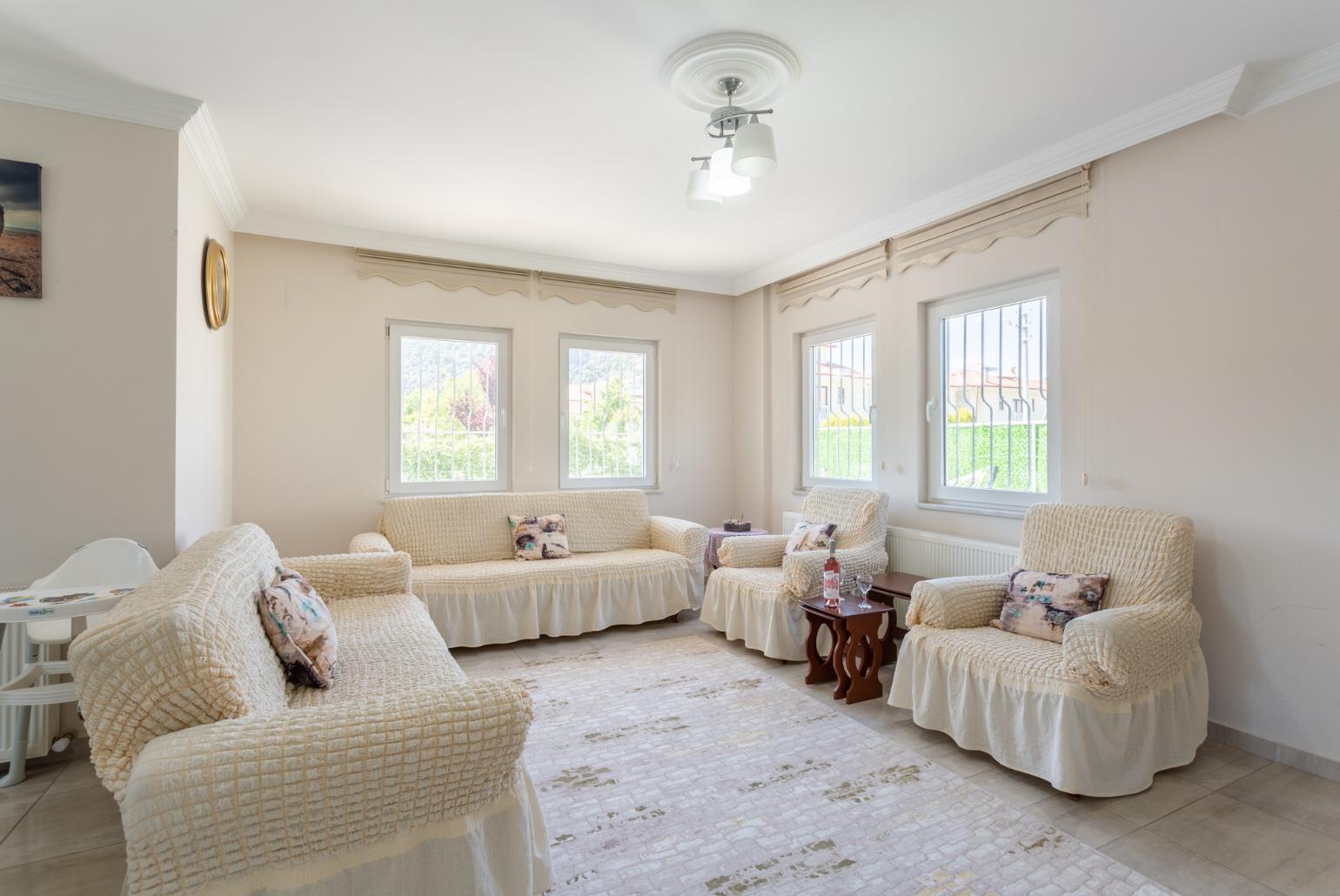 Open-plan living room with sofas, dining area, kitchen, A/C, WiFi internet, satellite TV, and terrace access