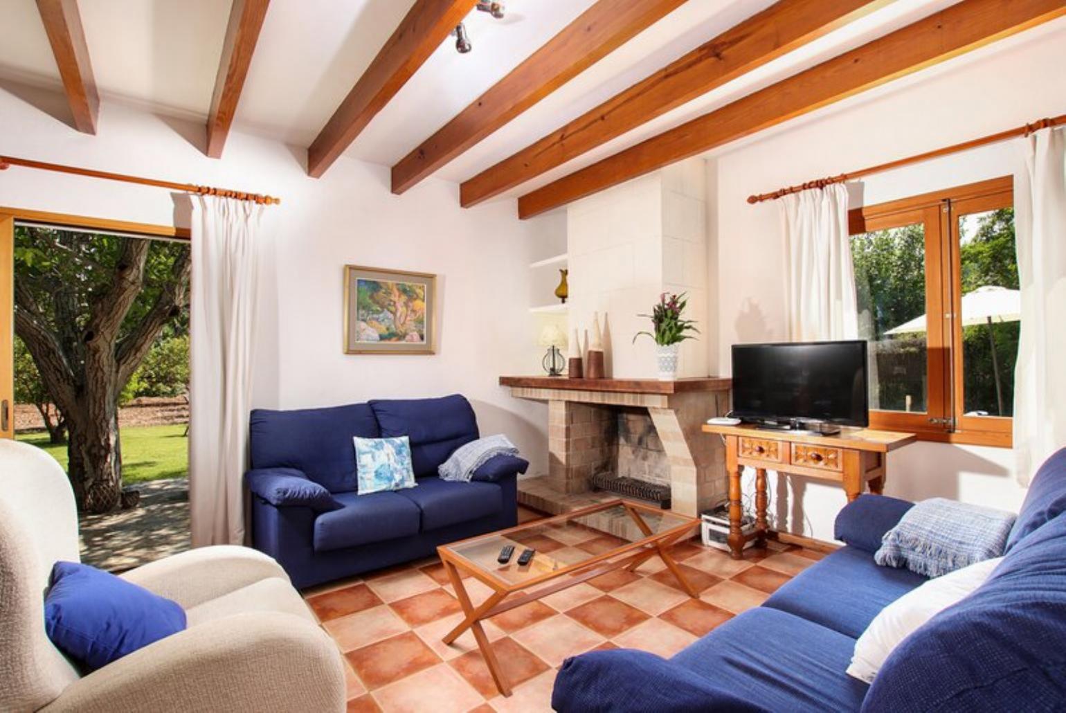 Living room with sofas, dining area, ornamental fireplace, A/C, WiFi internet, and satellite TV