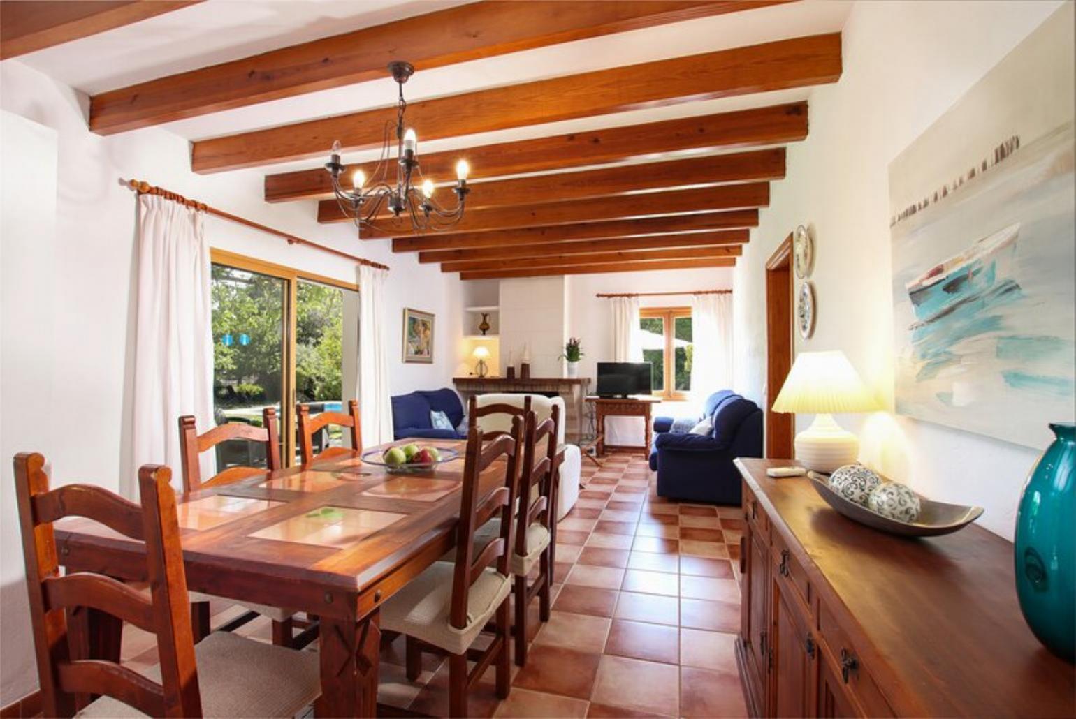 Living room with sofas, dining area, ornamental fireplace, A/C, WiFi internet, and satellite TV