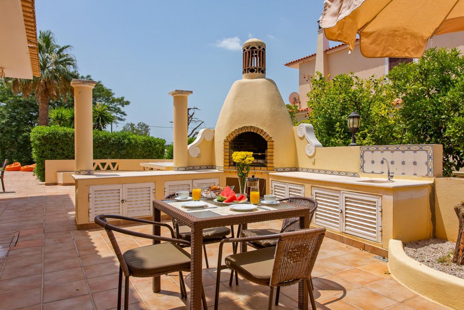 Outdoor BBQ with dining area.