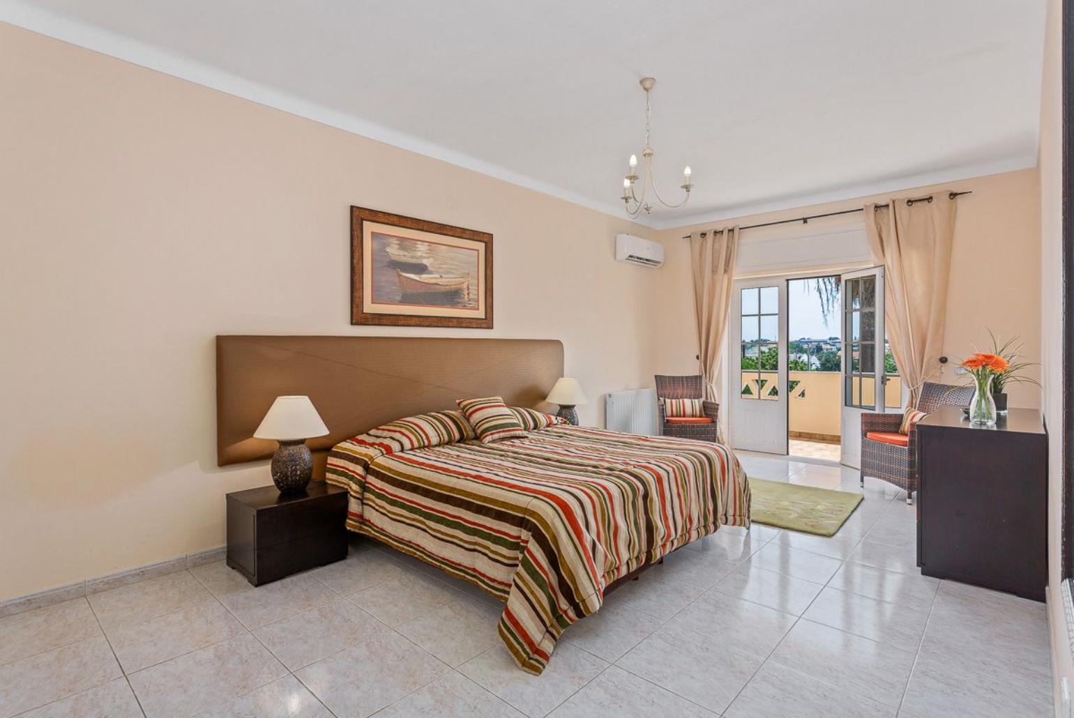 Double bedroom with AC , balcony access and en suite bathroom.