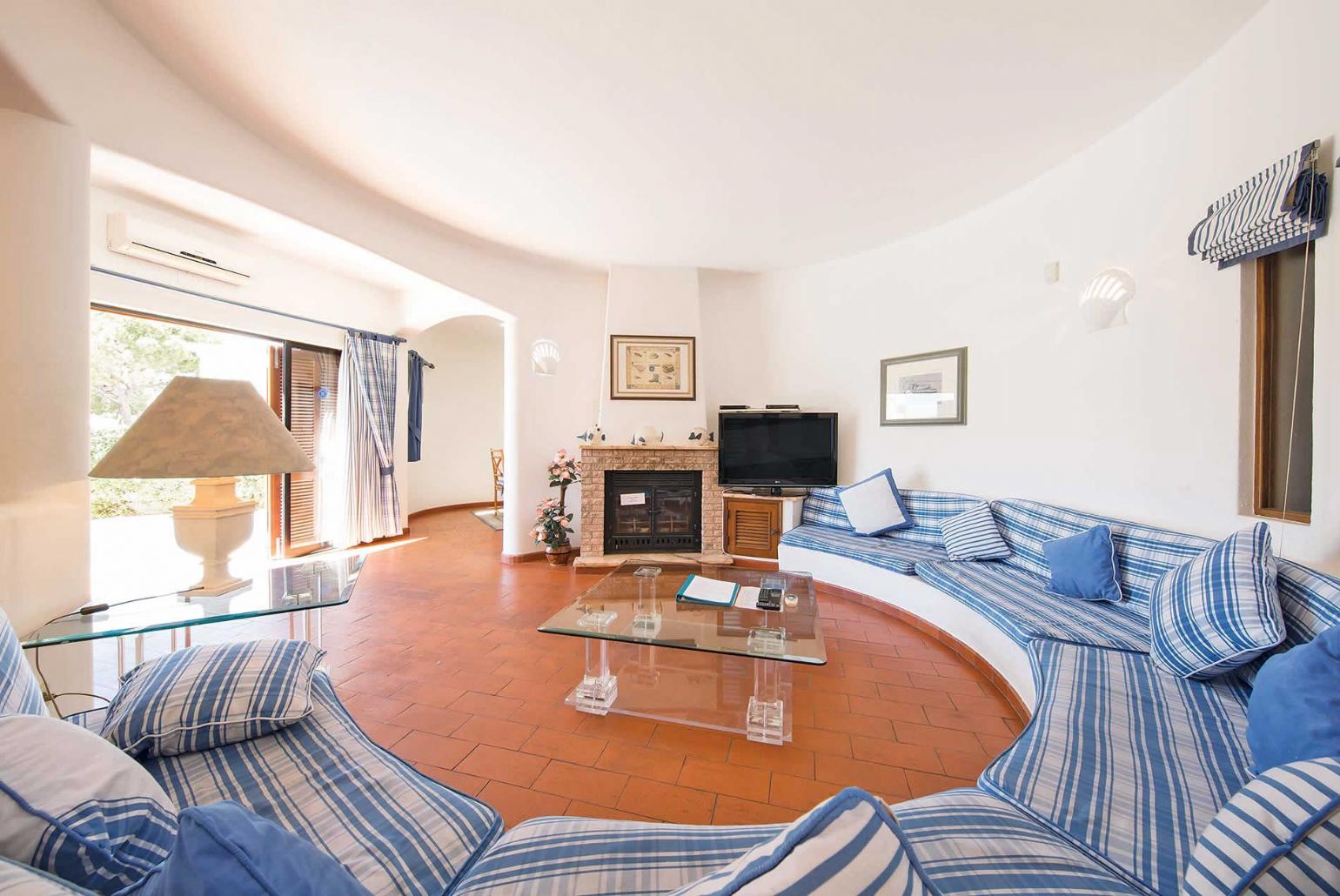 Open-plan living room with TV and dining area.