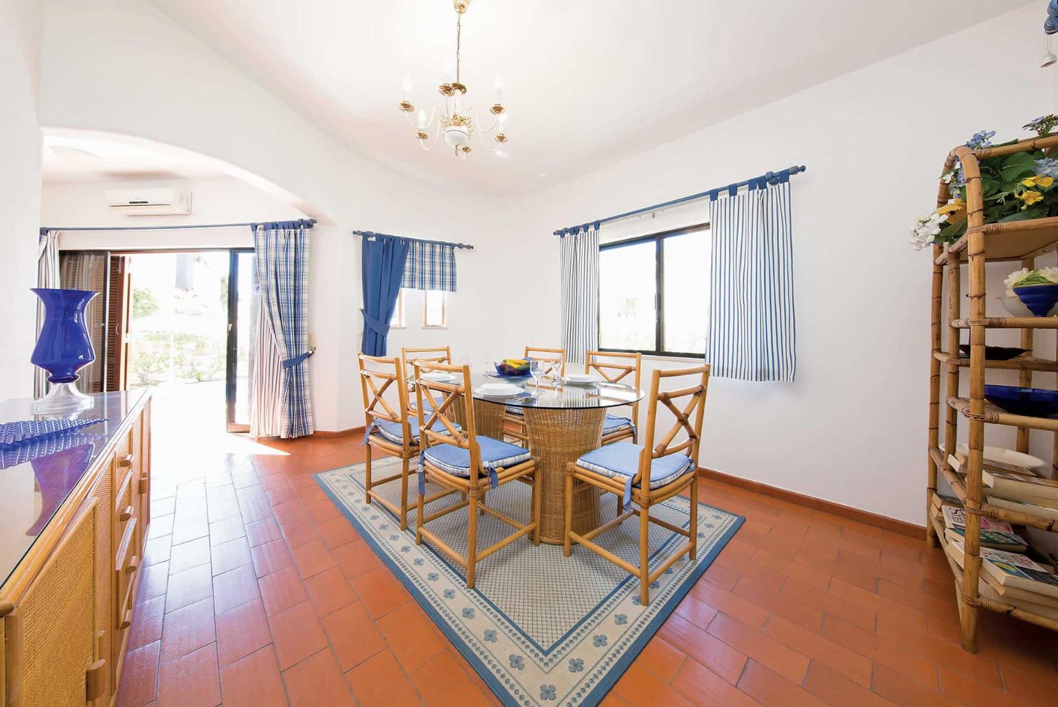 Open-plan living room with TV and dining area.