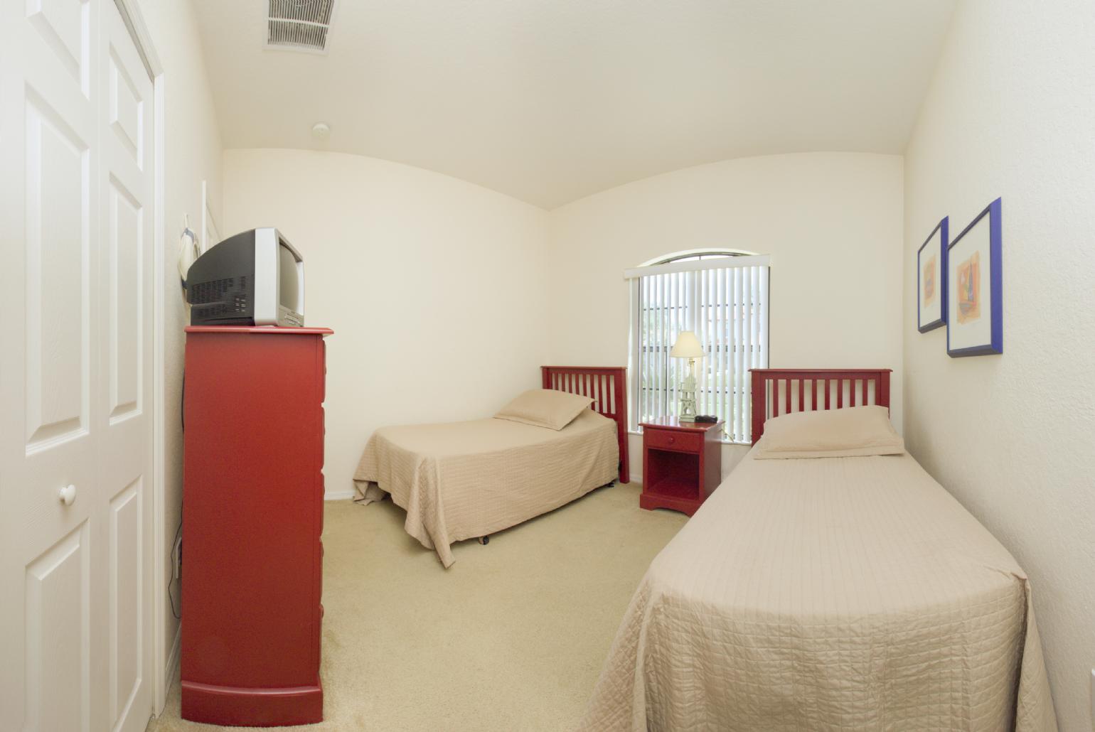 Twin bedroom with TV.