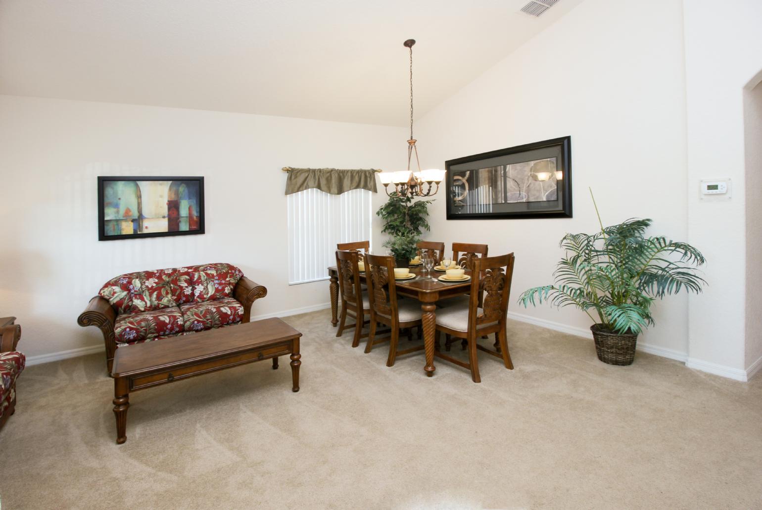 Open-plan living room with equipped kitchen and dining area.