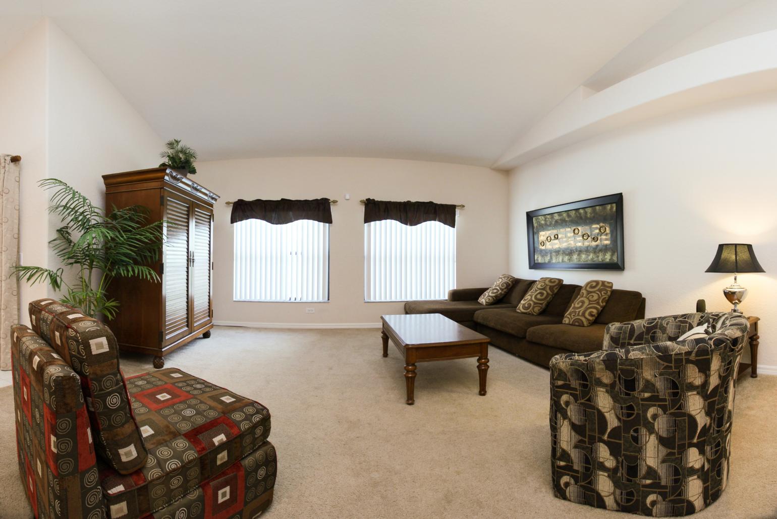 Open-plan living room with equipped kitchen and dining area.