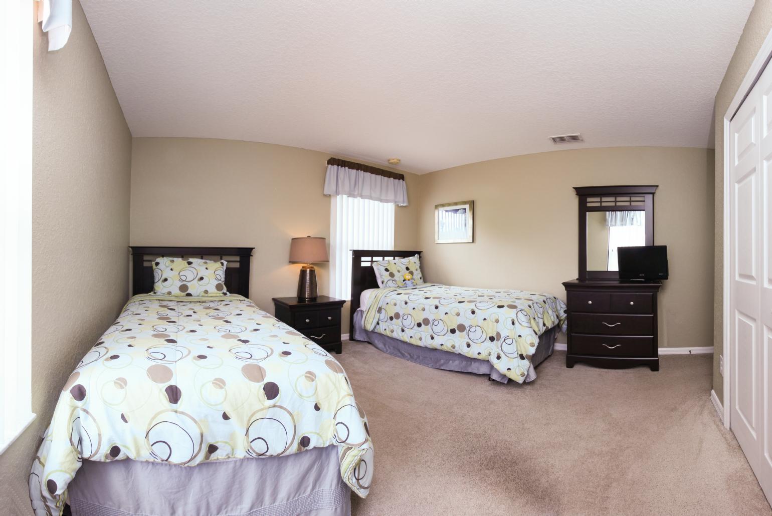 Twin bedroom with TV.