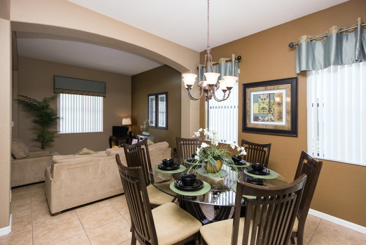 Open-plan living room with equipped kitchen and dining area.