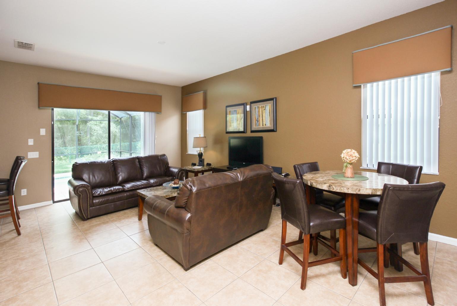 Open-plan living room with equipped kitchen and dining area.