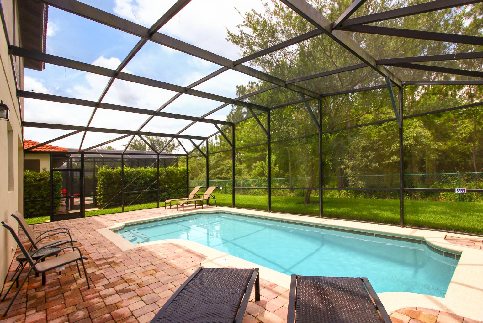 Private pool area with sunbeds.