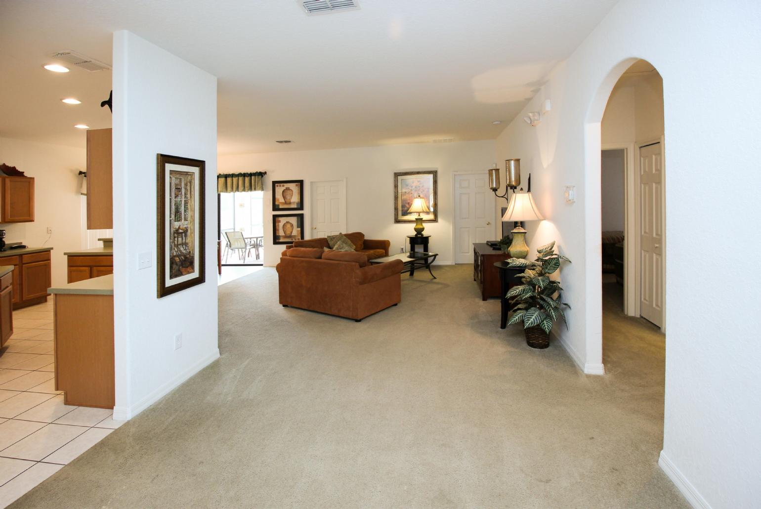 Open-plan living room with equipped kitchen and dining area.